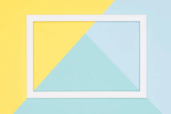 Abstract geometrical pastel blue, teal and yellow paper flat lay background. Minimalism, geometry and symmetry template with empty picture frame mock up.