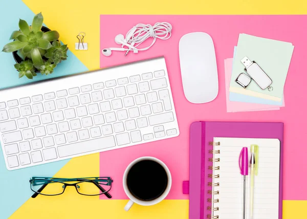 Office Desk Working Space Flat Lay. Top view photo of workspace with keyboard, notepad and coffee on pastel colored background. Student working desk concept.