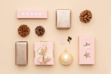 Pastel pink and gold minimal christmas background. Beautiful nordic christmas gifts isolated on beige background. Pink colored wrapped xmas boxes composition. clipart