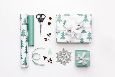 Gift wrapping composition. Nordic christmas gifts isolated on white background. Turquoise colored wrapped xmas boxes. clipart