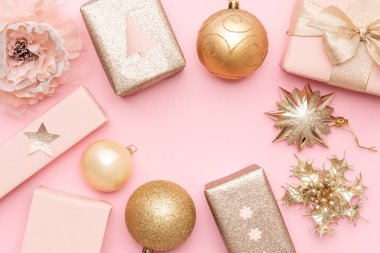 Pink and gold christmas gifts isolated on pastel pink background. Wrapped xmas boxes, christmas ornaments and baubles. Christmas mock up. clipart