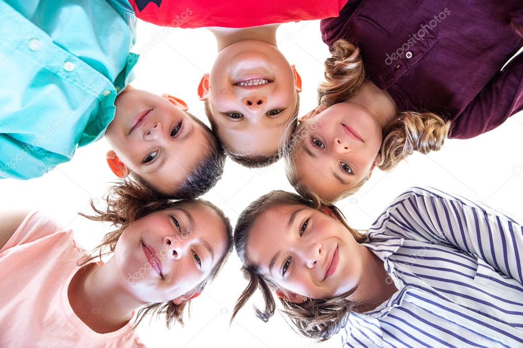 Group Of Children of Various Ages Standing in Circle, Looking Down Into Camera.