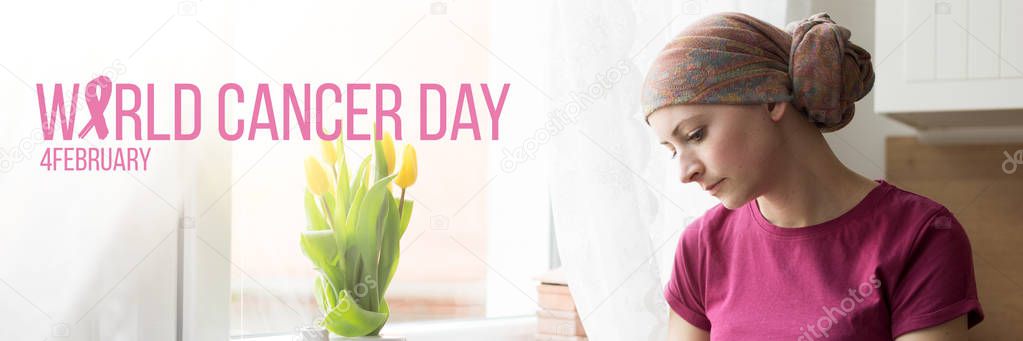 World Cancer Day Banner. Young adult female cancer patient wearing headscarf sitting by a window, with her head down. 
