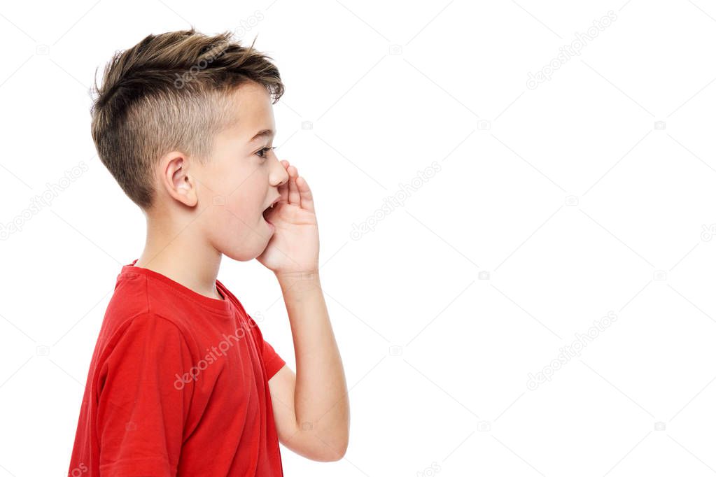 Cute boy in red T-shirt shouting. Speech therapy concept over white background. Side view.