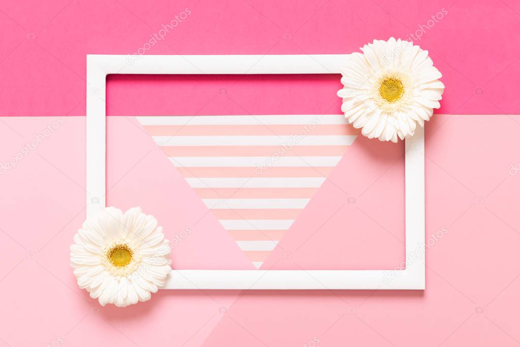 Happy Mother's Day, Women's Day, Valentine's Day or Birthday Pastel Pink Background. Flat lay mock up greeting card with beautiful gerbera flowers and picture frame.