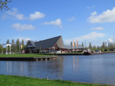 Stavoren, Hollanda - 23 Nisan 2018: Hollandalı balıkçı köyü durgun kanal büyük süpermarket