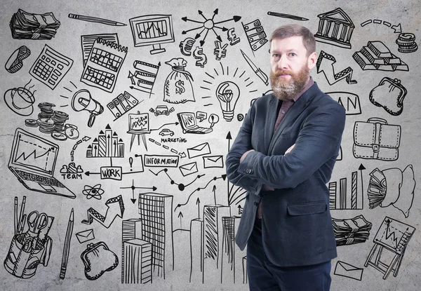 Portrait of bearded businessman presenting his business plan drawn on a concrete wall