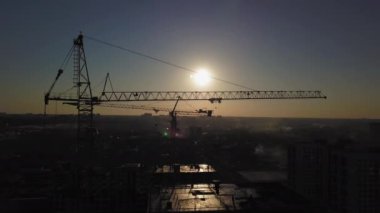 Gün batımında inşaat alanı. Binanın yakınındaki bir inşaat Vinci silueti