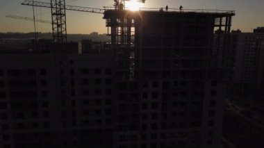 Gün batımında inşaat alanı. Binanın yakınındaki bir inşaat Vinci silueti