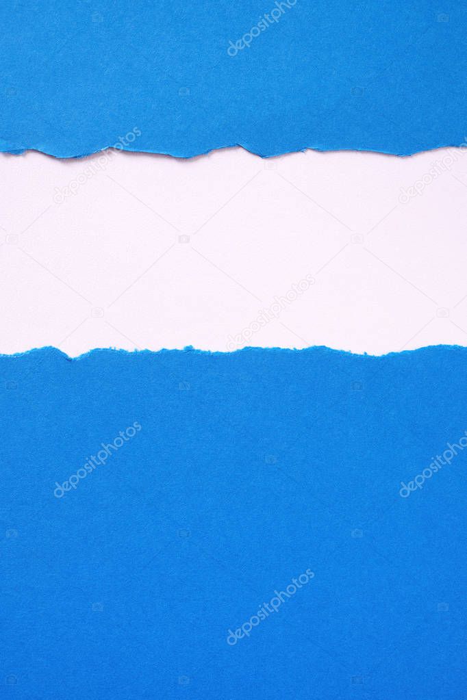Torn blue paper strip untidy edge border frame vertical