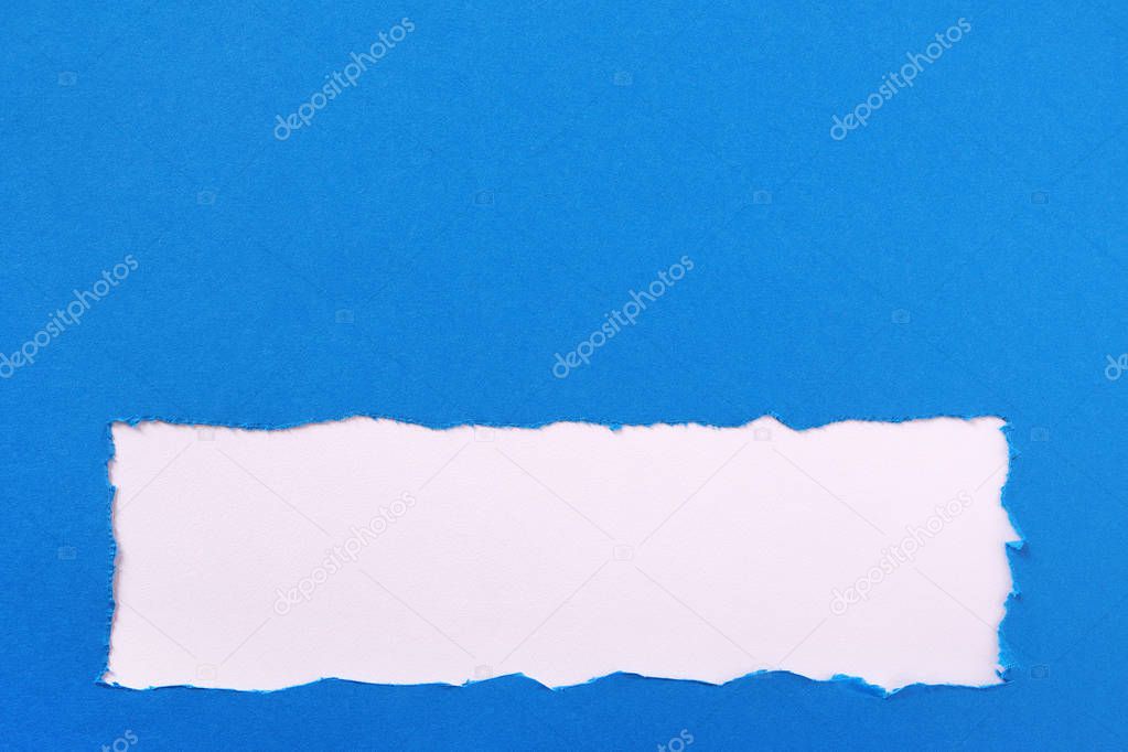 Torn blue paper strip ragged edge border frame