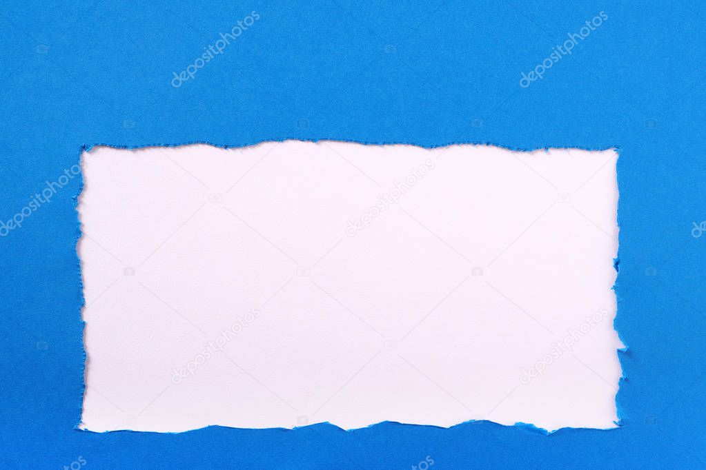 Torn blue paper ripped edge white background frame