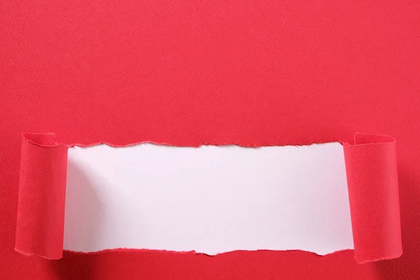 Torn red paper strip curled edge revealing white background