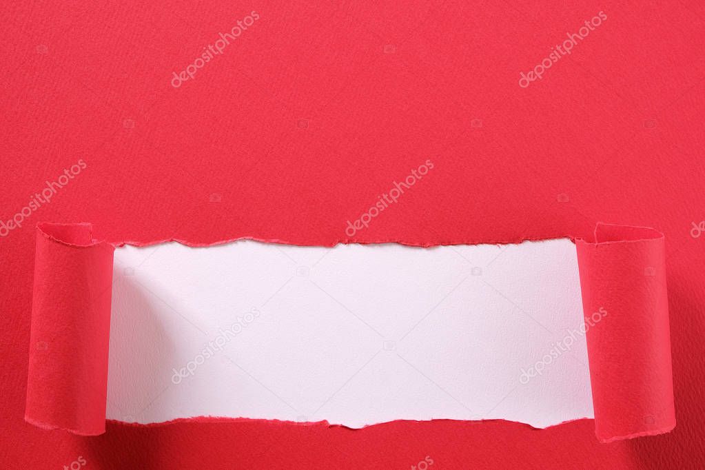 Torn red paper strip curled edge revealing white background