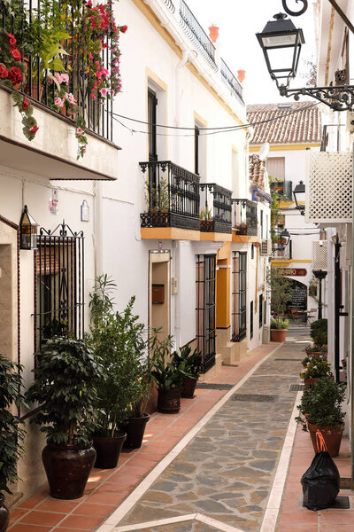Marbella old town, Malaga province, Andalucia, Spain - March 18, 2019 : traditional whitewashed village houses and narrow street