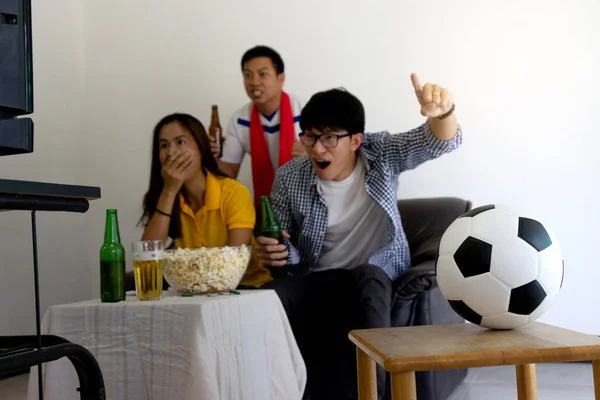 Group of young people man and woman watch Football match on tv broadcast program