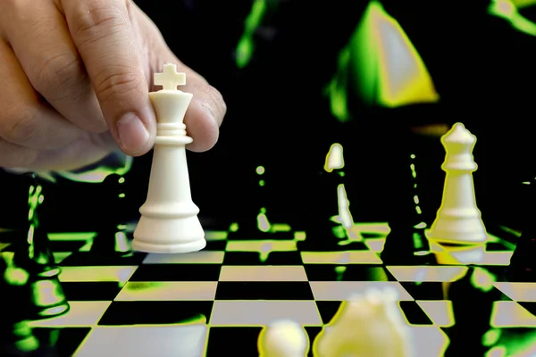 Businessman play chess use King Chess Piece white to crash overthrow the competitor concept business strategy for win