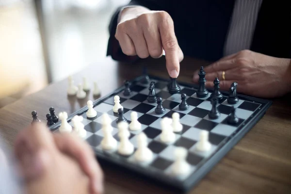 Businessman thinking how to play chess concept business strategy for win