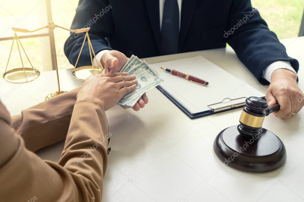 Judge lawyer gavel with bribe money in law firm concept corruption
