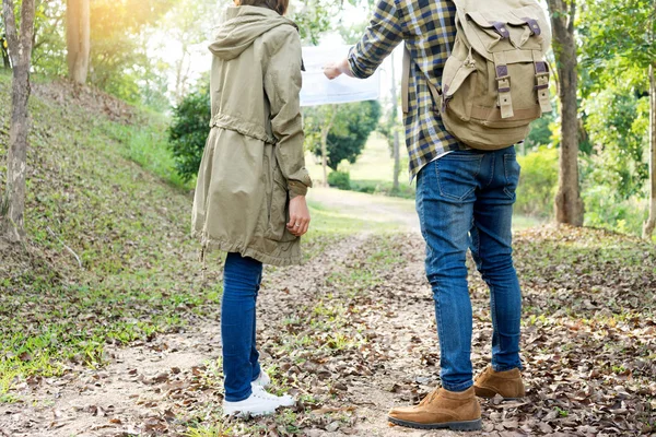 man and woman walk in the forest for their travel hiking journey