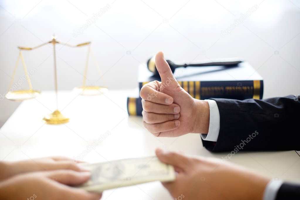 Judge lawyer gavel with bribe money in law firm concept corruption