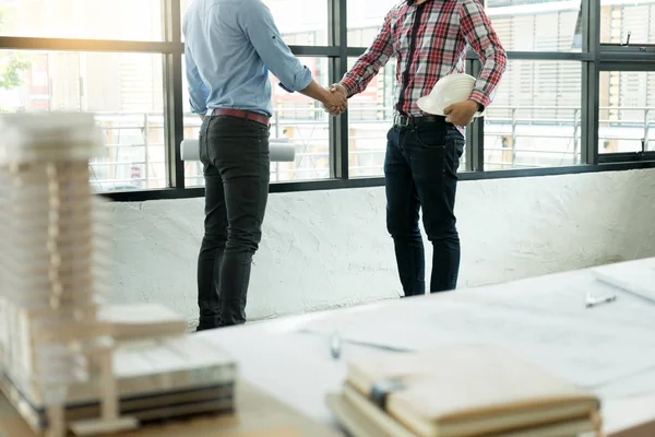 architect or engineer  handshake for teamwork and business project run good