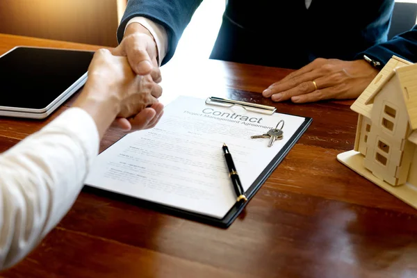 business man and customer handshake for their agreement to sign for contract for new home buy or rent