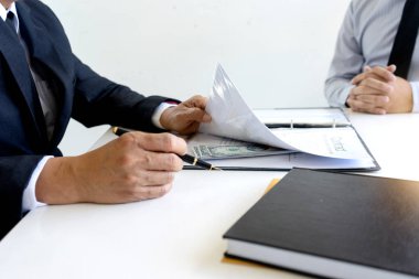 İş adamı temas kağıdı altındaki memura rüşvet verir, yolsuzluk parası kavramını benimser.