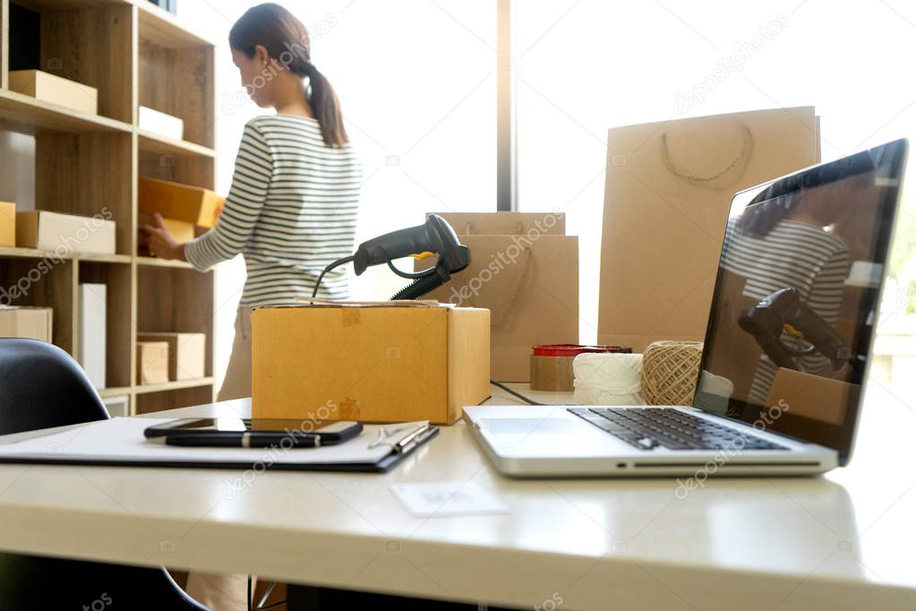 ecommerce concept, in office or home working prepare product in the box for send to customer who order by online. box for logistic with barcode scanner