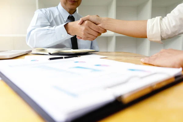 Two Business handshake and business people after discussing good deal of Trading contract and new projects for both companies, success, partnership, co worker . Meeting and greeting concept.