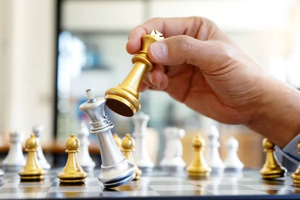 Businessman thinking and hold king chess