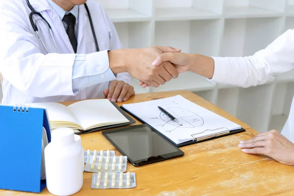 professional doctor handshake to the patient