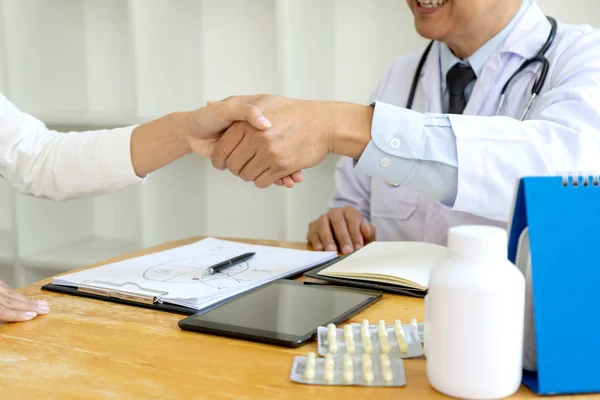 professional doctor handshake to the patient