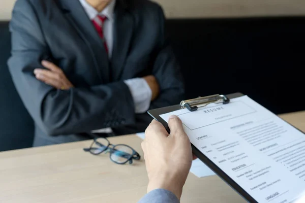 Job interview with corporate business manager arms folded