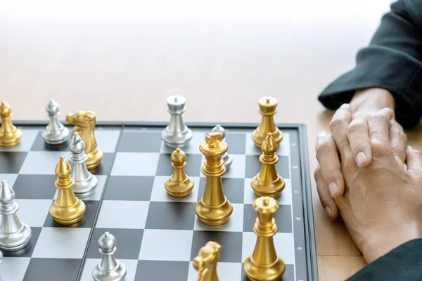 Businessman thinking and hold king chess on his hand,