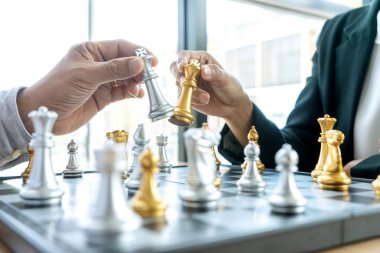 İş adamı düşünüyor ve satrancı elinde tutuyor.,