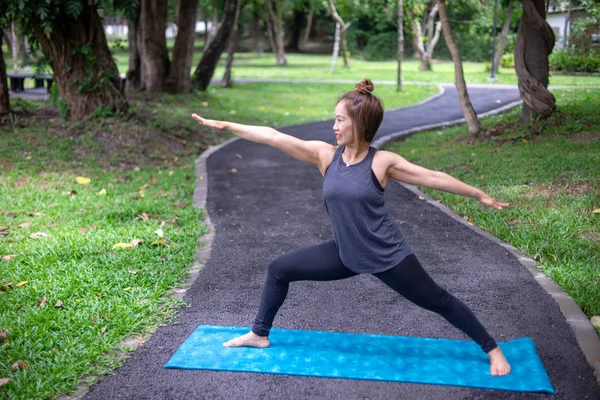 Woman more than 50 year old practicing yoga outdoor location