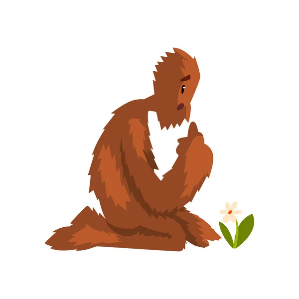 Funny bigfoot sitting on its knees and looking at flower, mythical creature cartoon character vector Illustration on a white background — Stock Vector