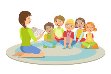 Küçük çocuklar yerdeki bir hikaye okuma öğretmen etrafında oturan grup