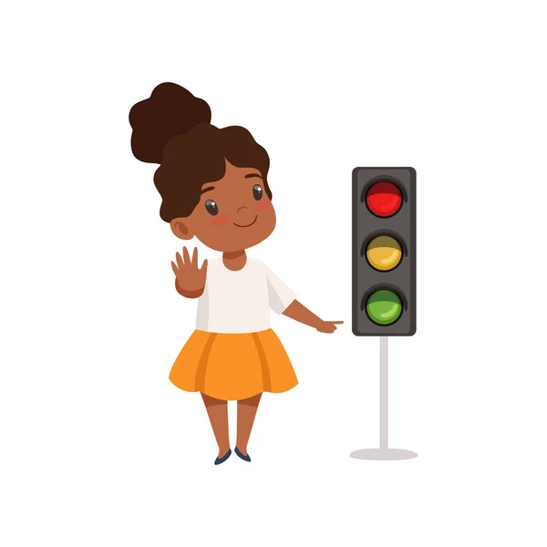 Niña afroamericana mostrando el gesto de parar y señalar con el dedo el semáforo, la educación sobre el tráfico, las reglas, la seguridad de los niños en la ilustración de vectores de tráfico — Archivo Imágenes Vectoriales