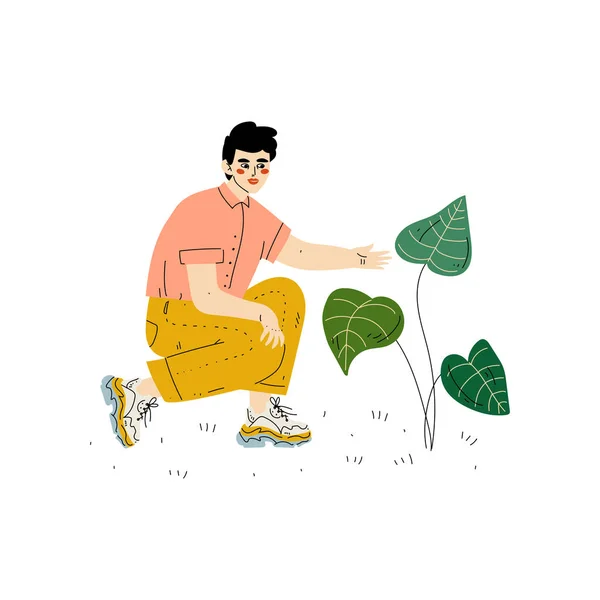 Jeune homme cultivant une plante, homme travaillant dans un jardin ou une ferme Illustration vectorielle — Image vectorielle