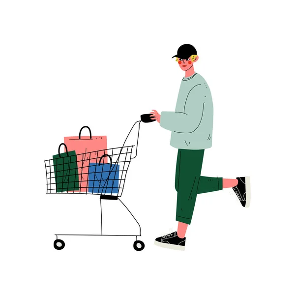 Young Man Walking with Shopping Cart, Guy Shopping at Store, Mall or Shop Vector Illustration — Stock Vector