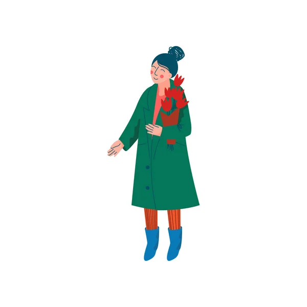 Piękna kobieta ubrana w zielony płaszcz i dzianinowy kapelusz stojący z bukiet wiosennych kwiatów wektor ilustracja — Wektor stockowy