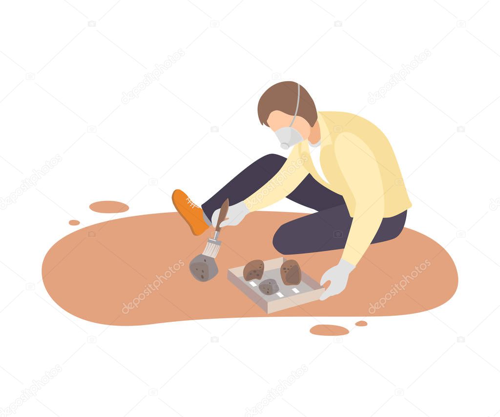 Male Archaeologist Sitting on Ground and Sweeping Dirt from Stones Using Brush, Paleontology Scientist Character Working on Excavations with Historical Artifacts Flat Vector Illustration