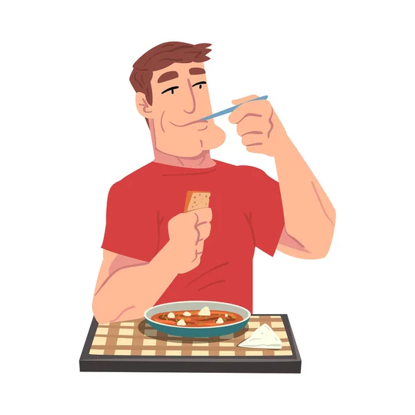 Jovem comendo delicioso guisado refeição, alegre cara sentado na mesa com xadrez toalha de mesa Cartoon Vector Ilustração — Vetor de Stock