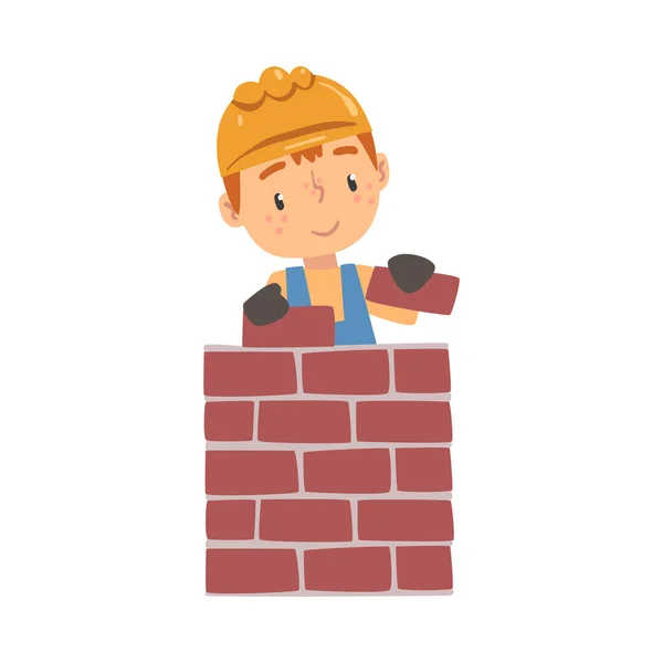 Jongen bouw arbeider leggen stenen in de muur, schattig weinig bouwer karakter dragen blauwe overall en harde hoed cartoon stijl vector illustratie — Stockvector