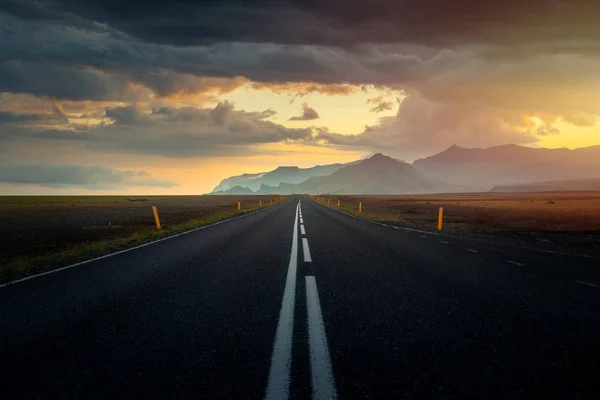 Stock image Typical icelandic landscape with empty road and scenic nature