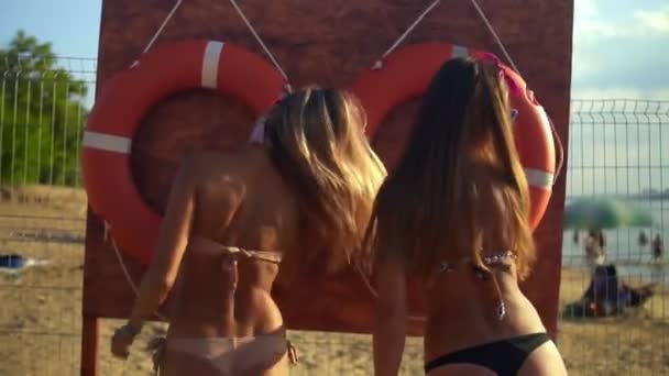 Girls Dancing on the Beach near of Lifebuoy — Stock Video