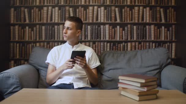 El hombre está leyendo el libro electrónico en el café — Vídeo de stock