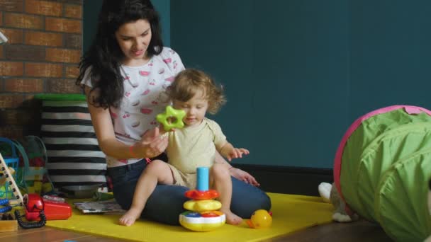 Mor och dotter leker med barnpyramid — Stockvideo